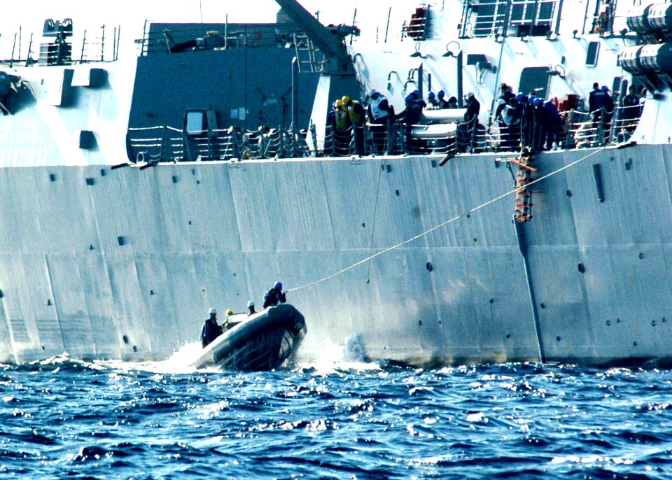 US Navy 060302-N-7359L-002 The Arleigh Burke-class guided missile destroyer USS Mason (DDG 87) Sailors transport personnel with in a rigid-hull inflatable boat (RHIB), during a replenishment at sea