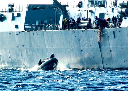 US Navy 060302-N-7359L-002 The Arleigh Burke-class guided missile destroyer USS Mason (DDG 87) Sailors transport personnel with in a rigid-hull inflatable boat (RHIB), during a replenishment at sea
