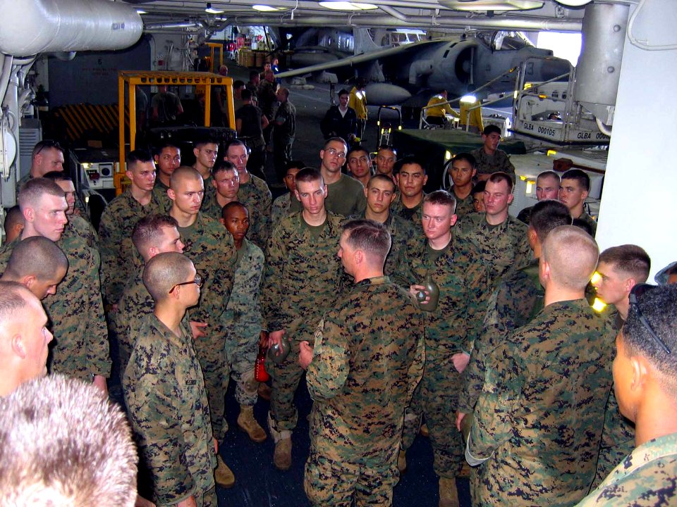 US Navy 060219-N-4880C-003 Marines from the 31st Marine Expeditionary Unit (31MEU) are briefed in the ship's hangar bay aboard the amphibious assault ship USS Essex (LHD 2), before going ashore to assist with rescue effo