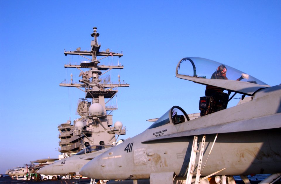 US Navy 060225-N-4776G-015 Airman Apprentice Frank Baylon assigned to the Fist of the Fleet of Strike Fighter Squadron Two Five (VFA-25) cleans the canopy of an F-A-18C Hornet