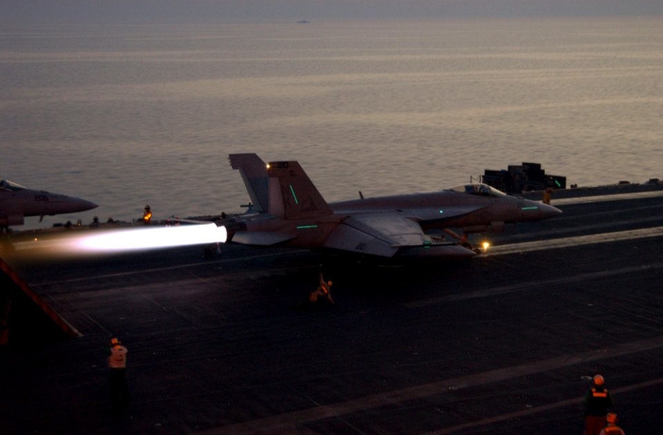 US Navy 060228-N-4776G-236 An F-A-18E Super Hornet assigned to the Eagles of Strike Fighter Squadron One One Five (VFA-115) throttles to full afterburner as it prepare to launch from the flight deck of the Nimitz-class aircraft