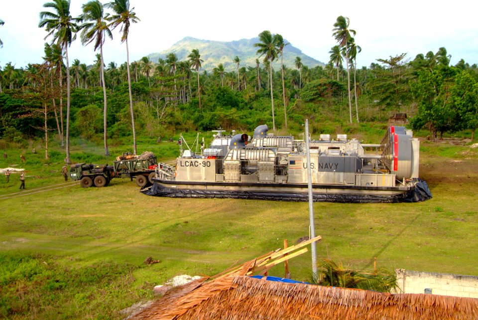 US Navy 060303-N-4772B-080 Marines assigned to the 31st Marine Service Support Group (MSSG) load equipment on a Landing Craft, Air Cushion (LCAC) on the island of Jolo, before heading out toward the amphibious dock landing ship