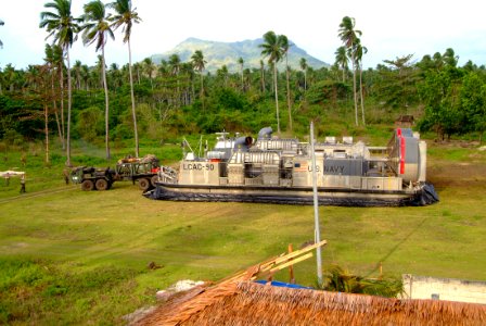 US Navy 060303-N-4772B-080 Marines assigned to the 31st Marine Service Support Group (MSSG) load equipment on a Landing Craft, Air Cushion (LCAC) on the island of Jolo, before heading out toward the amphibious dock landing ship