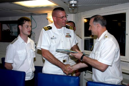 US Navy 060327-N-4658L-115 Vice Adm. Konstantin Sidenko, presents a Russian Pacific Fleet photo book to USS Chung-Hoon (DDG 93) Commanding Officer, Cmdr. Dave Welch