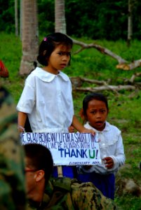 US Navy 060303-N-4772B-123 Townspeople from the local village of Tiptipon gather near the beach to bid farewell to U.S. service members assigned to the 31st Marine Service Support Group (MSSG) following a Civil Action Project i