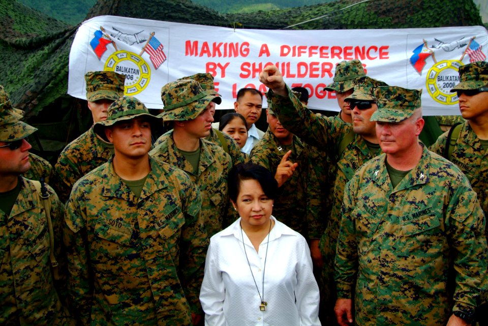 US Navy 060222-N-4772B-084 Philippine President Gloria Macapagal Arroyo meets with Commanding Officer, 31st Marine Expeditionary Unit (MEU) Col. Walter L. Miller near the site of a devastating landslide