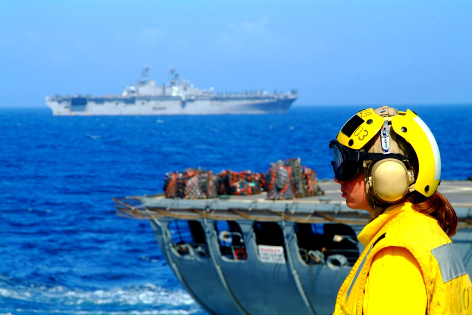 US Navy 060225-N-4772B-099 Landing Signal Enlisted (LSE), Gunner's Mate 3rd Class Nikole Povolish prepares for the next helicopter to reach the flight deck aboard the dock landing ship USS Harpers Ferry (LSD 49)