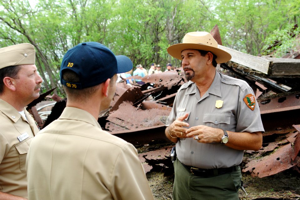 US Navy 060316-N-9643K-010 - National Park Service Ranger Daniel Martinez addresses a group of Sailors from the Pearl Harbor Surface Navy Association (SNA) at the site of the USS Arizona relics