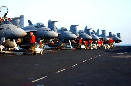 US Navy 060225-N-4776G-058 Aviation ordnancemen load ammunition onto F-A-18s before flight operations begin on the flight deck aboard the Nimitz-class aircraft carrier USS Ronald Reagan (CVN 76)