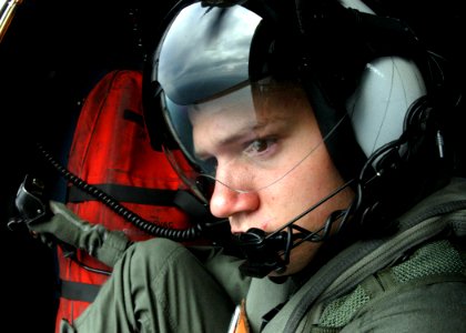 US Navy 060317-N-7526R-262 Aviation Warfare Systems Operator 3rd Class Karl Stiglbauer, assigned to the Warlords of Helicopter Anti-Submarine Squadron Light Five One (HSL-51), scans the horizon