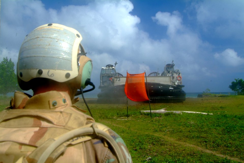 US Navy 060303-N-4772B-182 A member of Beachmaster Unit One, (BMU-1) Detachment Western Pacific guides a Landing Caraft, Air Cushio