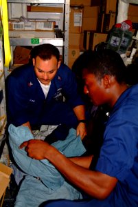 US Navy 060218-N-4772B-014 Hospital Corpsman 2nd Class Leonard H. Ray, left, and Hospital Corpsman 3rd Class John K. Holloman inventory medical supplies aboard the dock landing ship USS Harpers Ferry (LSD 49)