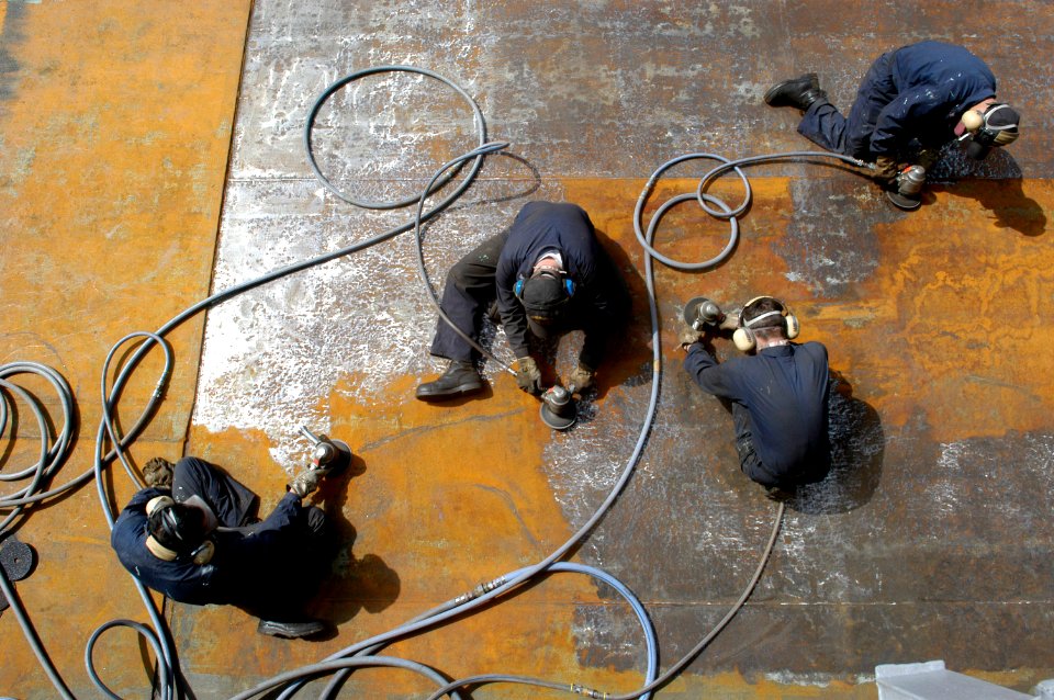 US Navy 060321-N-3136P-004 Combat Systems Department Sailors use grinders to smooth the surface of a Rolling Airframe Missile (RAM) mount aboard the conventionally-powered aircraft carrier USS Kitty Hawk (CV 63)