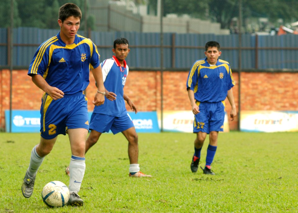 US Navy 060307-N-7526R-058 Seaman Jose Lopez, advances the soccer ball up the right wing during a match between the amphibious command ship USS Blue Ridge (LCC 19) and a local Malaysian team