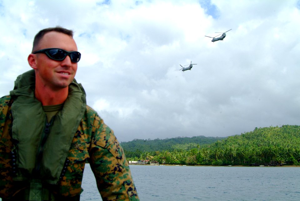 US Navy 060220-N-4772B-131 31st Marine Service Support Group (MSSG) 1st Lt. Theodore R. Smith surveys the beach line from a 11 meter Rigid Hull Inflatable Boat (RHIB)