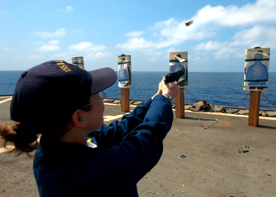 US Navy 060316-N-7526R-015 Ensign Erin Choromanski, fires a 9mm pistol at a target during small arms familiarization training on the flight deck aboard the amphibious command ship USS Blue Ridge (LCC 19)