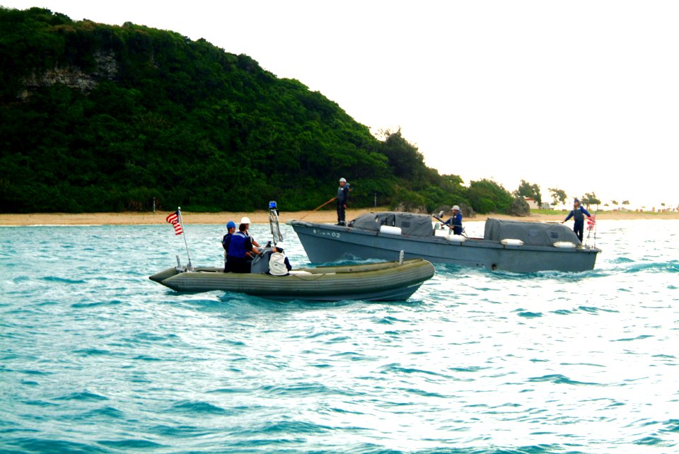 US Navy 060322-N-4772B-012 Amphibious dock landing ship USS Harpers Ferry's (LSD 49) Rigid Hull Inflatable Boat (RHIB) passes a Japanese Maritime Self Defense Force (JMSDF) craft in the waters just off White Beach, Okinawa