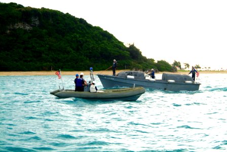 US Navy 060322-N-4772B-012 Amphibious dock landing ship USS Harpers Ferry's (LSD 49) Rigid Hull Inflatable Boat (RHIB) passes a Japanese Maritime Self Defense Force (JMSDF) craft in the waters just off White Beach, Okinawa
