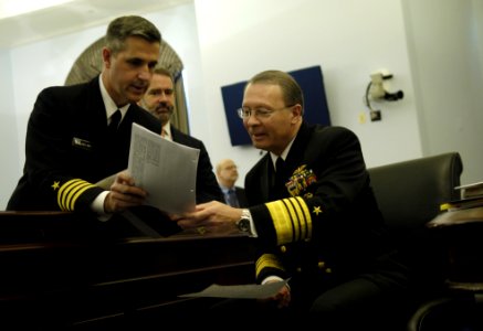 US Navy 060301-F-0193C-001 Vice Chairman of the Joint Chiefs of Staff, U.S. Navy Adm. Edmund Giambastiani, receives documents from Public Affairs Officer Capt. Greg Smith, before a hearing with the House Budget Committee photo