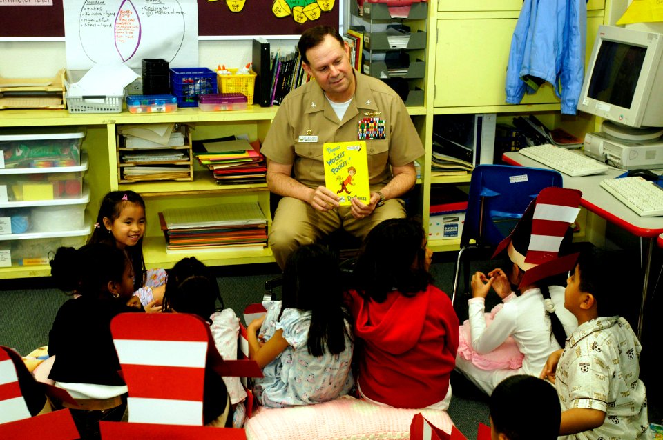 US Navy 060302-N-1960H-093 USS Kitty Hawk (CV 63) Commanding Officer, Capt. Ed McNamee, reads a Dr. Seuss book to a 2nd grade class at Sullivans Elementary School