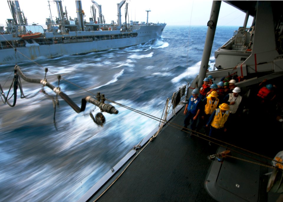 US Navy 060318-N-7526R-154 Amphibious command ship USS Blue Ridge (LCC 19) Sailors look on as a refueling probe crosses over the South China Sea,