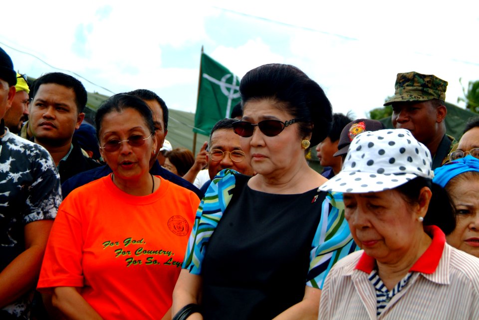 US Navy 060222-N-4772B-100 Wife of late Philippine President Ferdinand Marcos, Imelda Marcos, prays near the site of a devastating landslide that struck southern Leyte on Feb. 17, 2006