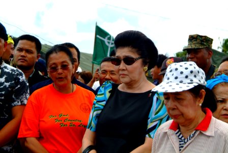 US Navy 060222-N-4772B-100 Wife of late Philippine President Ferdinand Marcos, Imelda Marcos, prays near the site of a devastating landslide that struck southern Leyte on Feb. 17, 2006