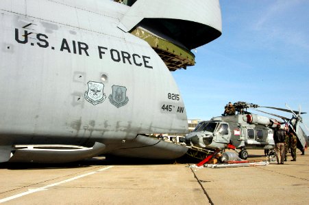 US Navy 060324-N-2832L-035 Sailors assigned to Helicopter Anti-Submarine Squadron Ten (HS-10), load two HH-60A Seahawk helicopters aboard an Air Force C-5 Galaxy photo