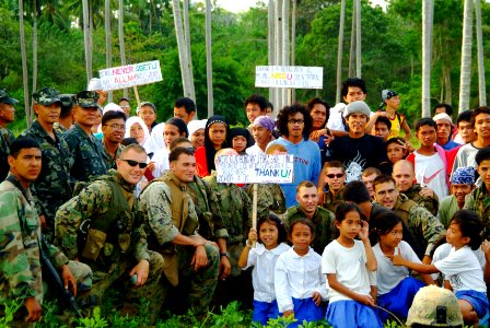 US Navy 060303-N-4772B-128 Philippine Marines and villagers from the nearby town of Tiptipon pose with U.S. Marines and Sailors assigned to the 31st Marine Service Support Group (MSSG) before they depart the island