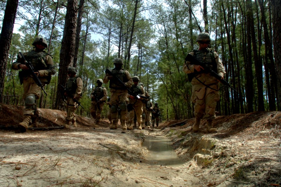 US Navy 060405-N-4097B-028 Sailors patrol through the woods during a simulated Improvised Explosive Device (IED) awareness exercise as part of the Navy's Individual Augmentee Combat Training course at Fort Jackson, S.C