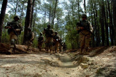 US Navy 060405-N-4097B-028 Sailors patrol through the woods during a simulated Improvised Explosive Device (IED) awareness exercise as part of the Navy's Individual Augmentee Combat Training course at Fort Jackson, S.C