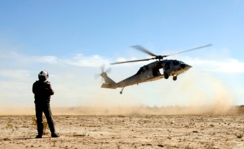 US Navy 060223-N-9500T-114 Photographer's Mate 1st Class Daniel Woods, assigned to Fleet Public Affairs Center, Pacific, documents a MH-60S Seahawk assigned to Helicopter Sea Combat Squadron Three