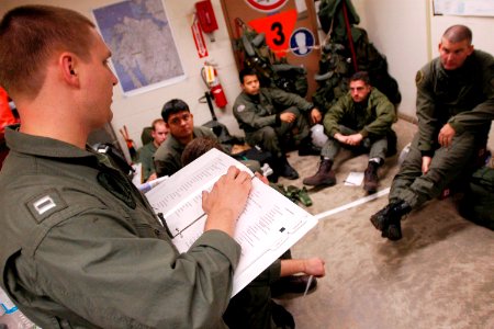 US Navy 060327-N-6074Y-003 Lt. Greg C. Knutson, a pilot assigned to Helicopter Anti-Submarine Squadron Two (HS-2) Golden Falcons, briefs fellow pilots and air crew prior to an evening combat search and rescue (CSAR) training mi
