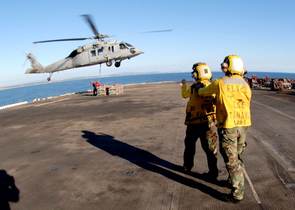 US Navy 060411-N-0716S-014 Aviation Boatswain's Mate 3rd Class Jason Chevillard instructs Aviation Boatswain's Mate Airman Apprentice Jenna White on basic aircraft handling procedures