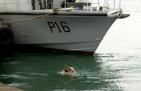 US Navy 060313-F-9074R-009 A U.S. Navy explosive ordnance disposal (EOD) Sailor performs a routine force protection dive at the Port of Djibouti photo