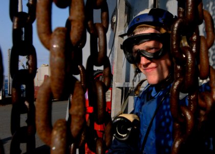 US Navy 060323-N-7526R-006 Amphibious command ship USS Blue Ridge (LCC 19) flight deck phone talker, Seaman Elliot Kaiser, looks over the flight deck as an Army UH-60L