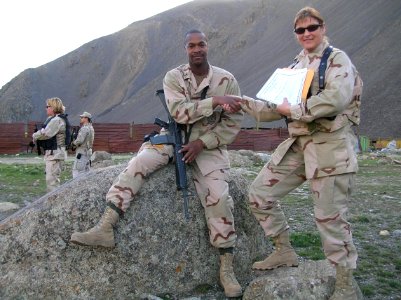 US Navy 060329-N-9999X-003 Master-at-Arms 1st Class Daniels shake hands with Chief Engineman K. Patti after completing the E-7 Navy Wide Exam in a secure area of Afghanistan
