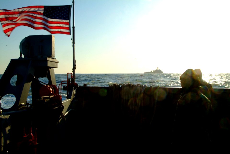 US Navy 060330-N-4772B-231 Sailors assigned to the Assault Craft Unit One (ACU-1) look out at the amphibious dock landing ship USS Harpers Ferry (LSD 49)