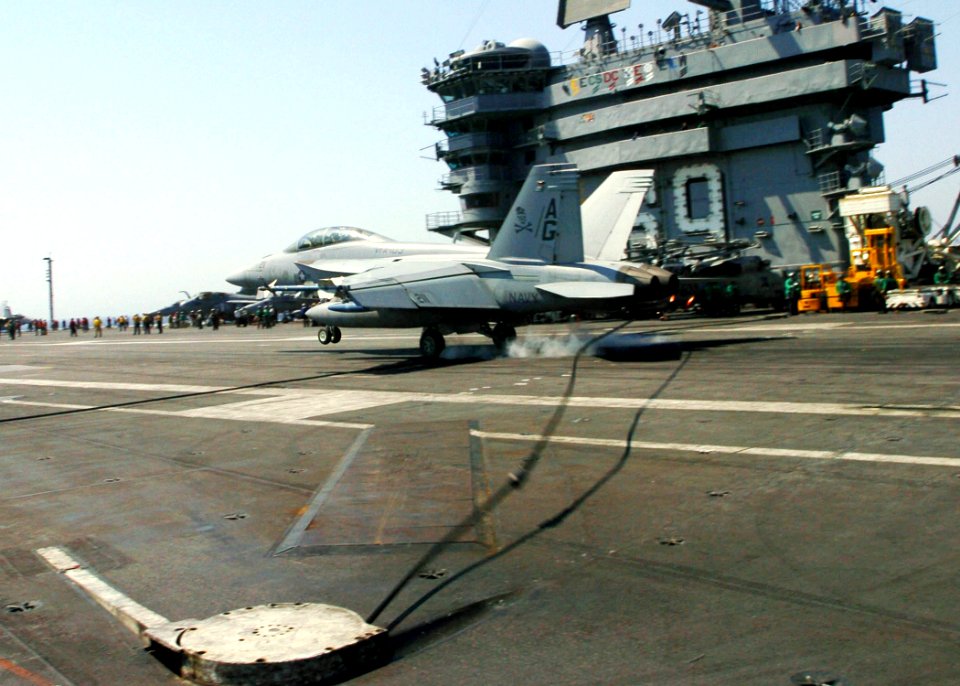 US Navy 060415-N-7359L-003 An F-A-18F Super Hornet, assigned to the Jolly Rogers of Strike Fighter Squadron One Zero Three (VFA-103), makes an arrested landing