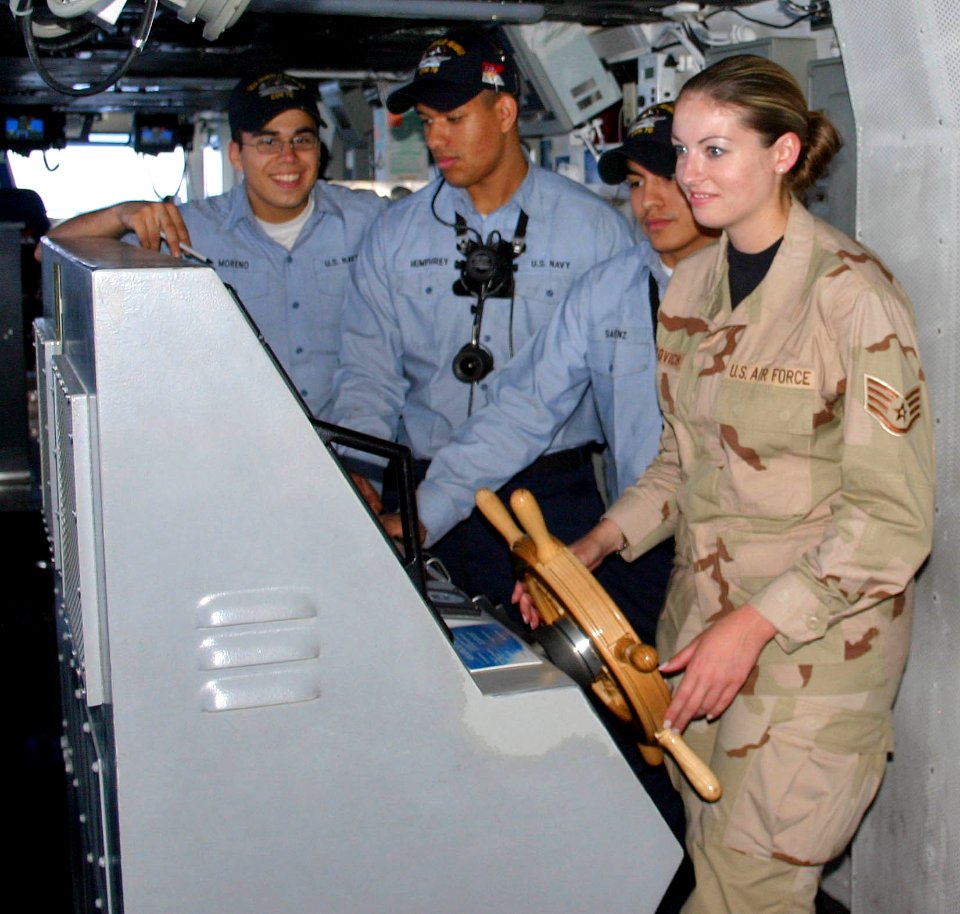 US Navy 060330-F-6554K-029 Staff Sgt. Melissa Koskovich steer the Nimitz-class aircraft carrier USS Ronald Reagan (CVN 76) during an orientation tour