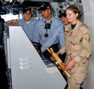 US Navy 060330-F-6554K-029 Staff Sgt. Melissa Koskovich steer the Nimitz-class aircraft carrier USS Ronald Reagan (CVN 76) during an orientation tour