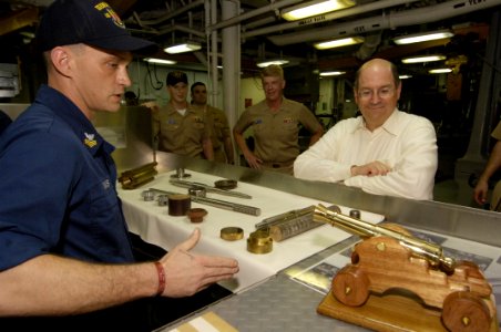 US Navy 060419-N-2568S-139 Machinery Repairman 1st Class Robert Mims describes to Secretary of the Navy (SECNAV) the Honorable, Dr. Donald C. Winter several types of work the machine shop is capable of producing