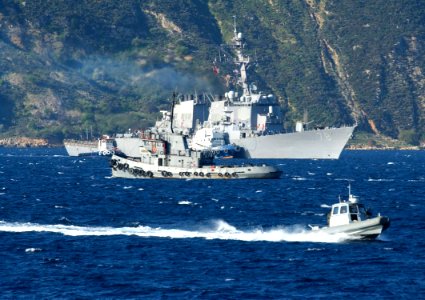 US Navy 060401-N-0780F-001 A harbor security boat patrols the area as the guided missile destroyer USS Porter (DDG 78) arrives for a routine port visit