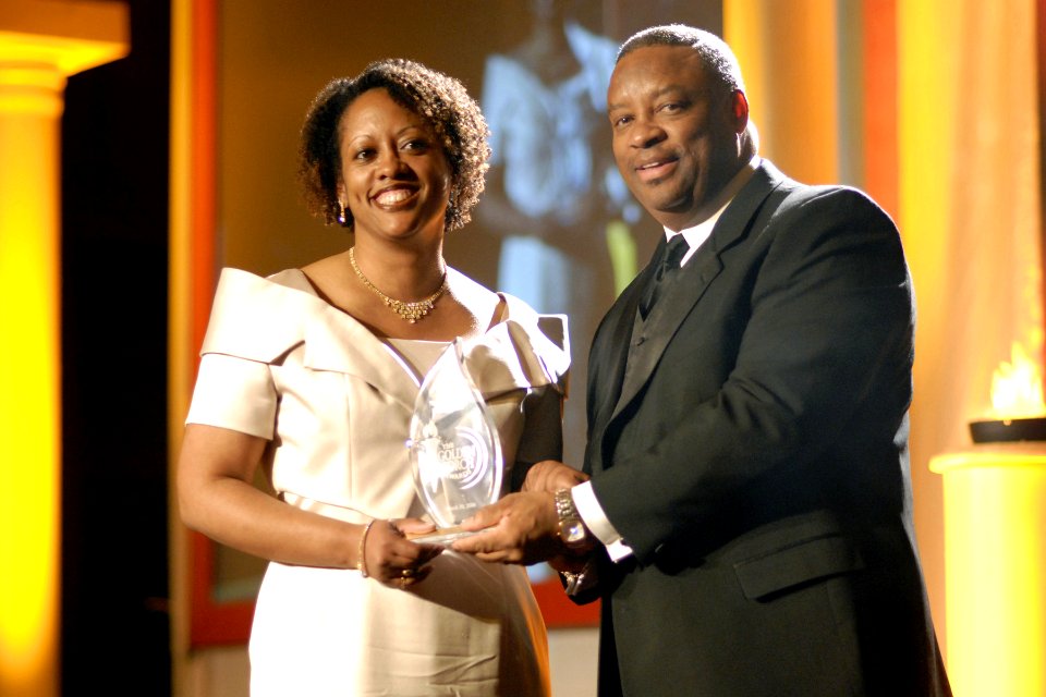 US Navy 060330-N-7170H-001 Zachary Lemelle, presents Kim Parker Brown, of Naval Facilities Engineering Command Headquarters, with the Golden Torch Award