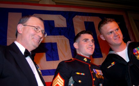 US Navy 060322-F-5107H-025 Joint Chiefs of Staff Vice Chairman, Adm. Edmund Giambastiani presents Marine Corps Sgt. Michael Donnelly and Petty Officer 3rd Class Justin Ledsome with a USO award for their service in Iraq