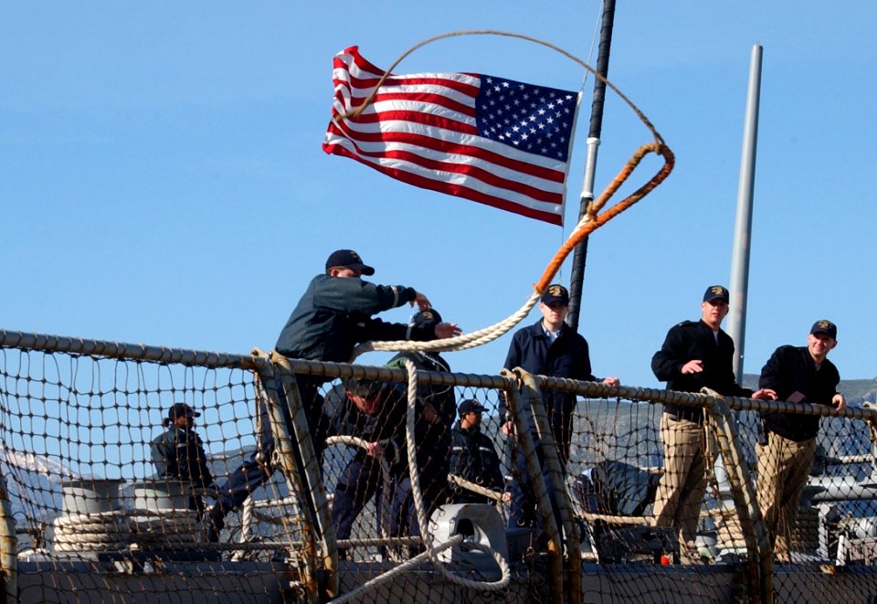 US Navy 060401-N-0780F-003 A Sailor heaves a mooring line ashore as the guided missile destroyer USS Porter (DDG 78) arrives for a routine port visit