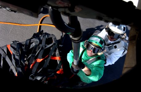 US Navy 060420-N-4776G-115 A Sailor and his spotter latches a cargo pendant to the bottom of an HH-60H Seahawk helicopter assigned to the Black Knights of Helicopter Anti-Submarine Squadron Four (HS-4) during a stimulated verti