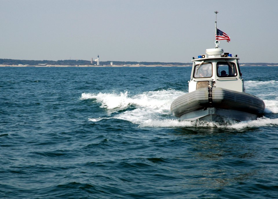 US Navy 060331-N-1464F-004 A 10-meter Rigid Hull Inflatable Boat (RHIB), provides security escort for the guided-missile submarine USS Florida (SSGN 728)