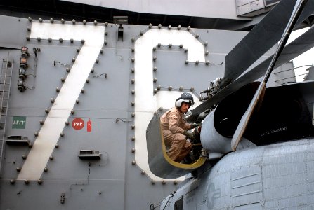 US Navy 060402-N-0555B-134 Lt.j.g. Brandon Sheets performs a pre-flight inspection of an SH-60 Seahawk