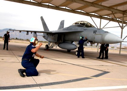 US Navy 060403-F-3177P-042 Crew members assigned to the Black Aces of Strike Fighter Squadron Four One (VFA-41) conducts post flight checks photo